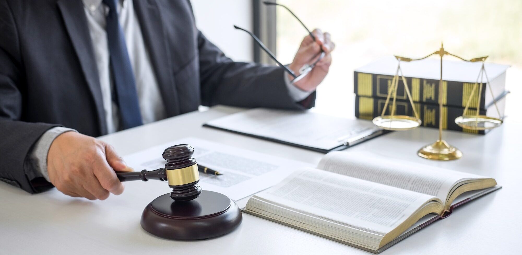 Judge gavel with Justice lawyers, Businessman in suit or lawyer working on a documents in courtroom